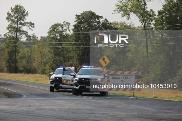 Police block local roads after mandatory evacuations have been ordered during a fast-moving wildfire in Walker County, Texas.  