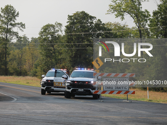 Police block local roads after mandatory evacuations have been ordered during a fast-moving wildfire in Walker County, Texas.  (