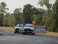 Police block local roads after mandatory evacuations have been ordered during a fast-moving wildfire in Walker County, Texas.  (