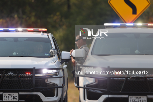 Police block local roads after mandatory evacuations have been ordered during a fast-moving wildfire in Walker County, Texas.  