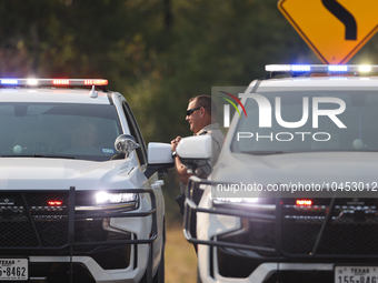 Police block local roads after mandatory evacuations have been ordered during a fast-moving wildfire in Walker County, Texas.  (