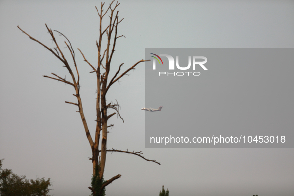 A firefighting aircraft passes through smoke from a wildfire in Walker County, Texas on September 2, 2023.  