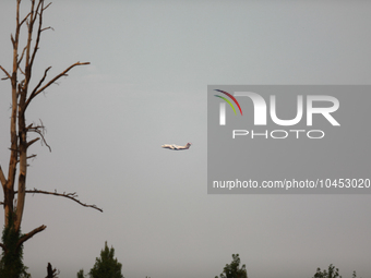 A firefighting aircraft passes through smoke from a wildfire in Walker County, Texas on September 2, 2023.  (