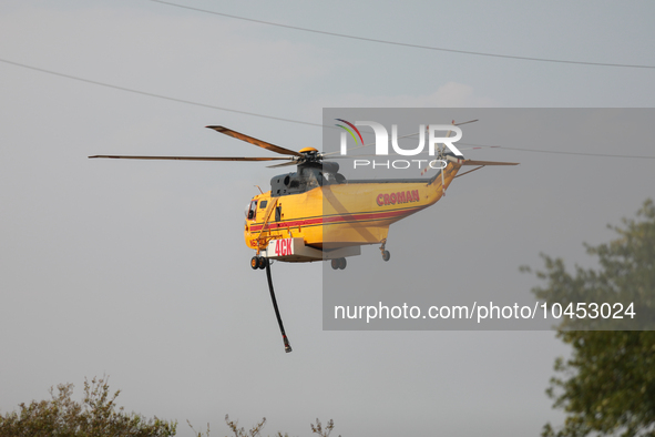 Helicopters refuel at Huntsville Municipal Airport before heading back to the fire site on September 2, 2023.  