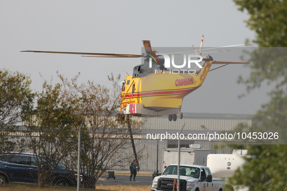 Helicopters refuel at Huntsville Municipal Airport before heading back to the fire site on September 2, 2023.  