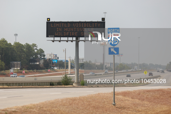 Signs along northbound Interstate 45 warn drivers of the wildfire on September 2, 2023 between Houston and Huntsville, Texas.  