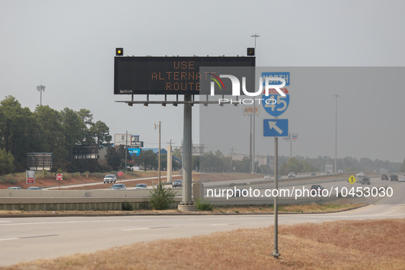 Signs along northbound Interstate 45 warn drivers of the wildfire on September 2, 2023 between Houston and Huntsville, Texas.  