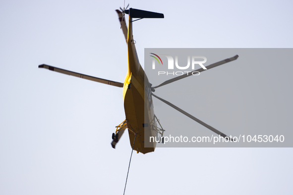 Helicopters help with the fire suppression effort during a large and fast-moving wildfire in Walker County, Texas on September 2, 2023.  