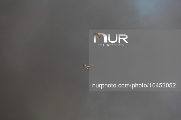 A firefighting aircraft is seen enveloped in smoke from a wildfire in Walker County, Texas on September 2, 2023.  