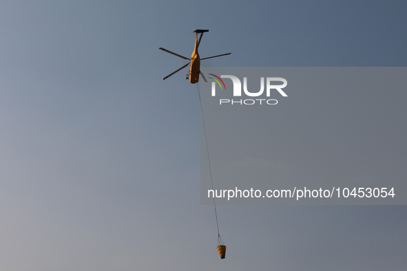 Helicopters help with the fire suppression effort during a large and fast-moving wildfire in Walker County, Texas on September 2, 2023.  