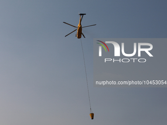 Helicopters help with the fire suppression effort during a large and fast-moving wildfire in Walker County, Texas on September 2, 2023.  (