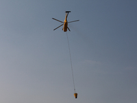 Helicopters help with the fire suppression effort during a large and fast-moving wildfire in Walker County, Texas on September 2, 2023.  (