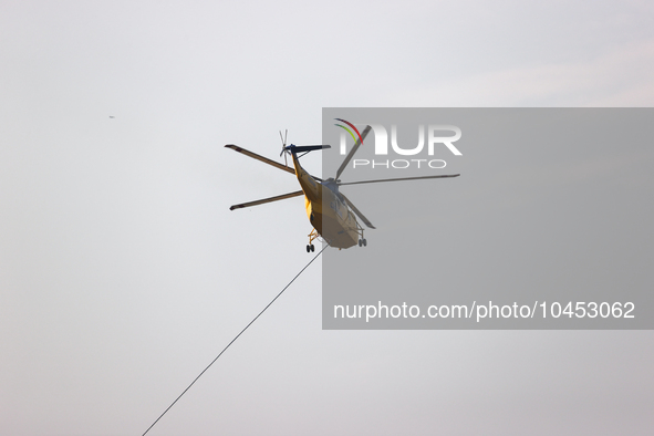 Helicopters help with the fire suppression effort during a large and fast-moving wildfire in Walker County, Texas on September 2, 2023.  