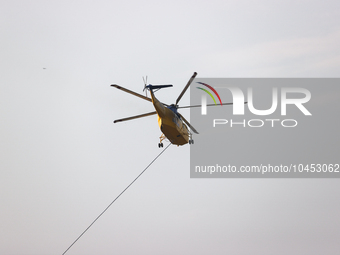 Helicopters help with the fire suppression effort during a large and fast-moving wildfire in Walker County, Texas on September 2, 2023.  (