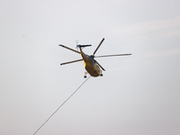 Helicopters help with the fire suppression effort during a large and fast-moving wildfire in Walker County, Texas on September 2, 2023.  (