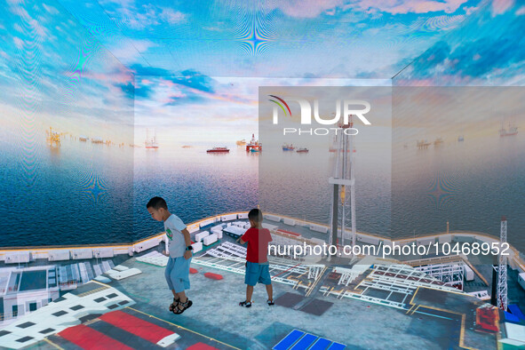  Two children visit the CNPC booth at the 2023 SMART CHINA EXPO in Chongqing, China, Sept. 5, 2023. 