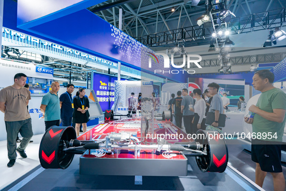  Citizens look at the architecture of new energy vehicles at the 2023 SMART CHINA EXPO in Chongqing, China, Sept. 5, 2023. 