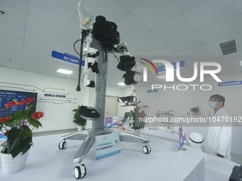 A medical worker watches a one-leg favoring rehabilitation robot exercise at the accessory center of Hangzhou Rehabilitation Hospital in Han...