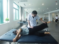 A medical worker massages a citizen's lower limbs at the rehabilitation center of Hangzhou Rehabilitation Hospital in Hangzhou, east China's...