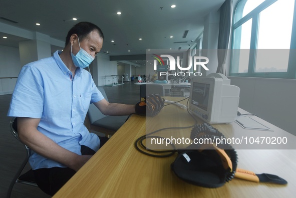 Citizens perform finger recovery training at Hangzhou Rehabilitation Hospital in Hangzhou, east China's Zhejiang province, Sept 6, 2023. 