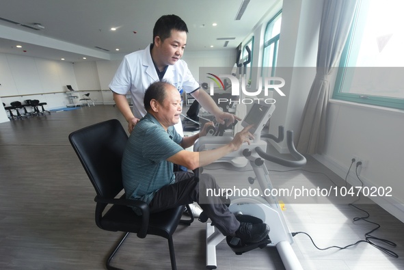 Citizens perform leg and foot recovery training with the help of medical staff at Hangzhou Rehabilitation Hospital in Hangzhou, East China's...