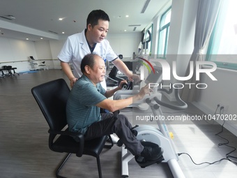 Citizens perform leg and foot recovery training with the help of medical staff at Hangzhou Rehabilitation Hospital in Hangzhou, East China's...