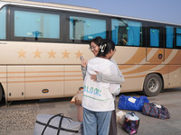 DEZHOU, CHINA - SEPTEMBER 7, 2023 - Two volunteer students from Shandong Dezhou University hug each other in Dezhou city, Shandong province,...