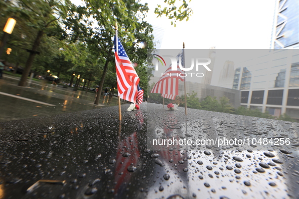 Flowers and US flags are laid on one of the South Pool panels at World Trade Center Memorial to commemorate the 9/11 Anniversary in New York...