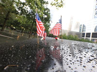 Flowers and US flags are laid on one of the South Pool panels at World Trade Center Memorial to commemorate the 9/11 Anniversary in New York...