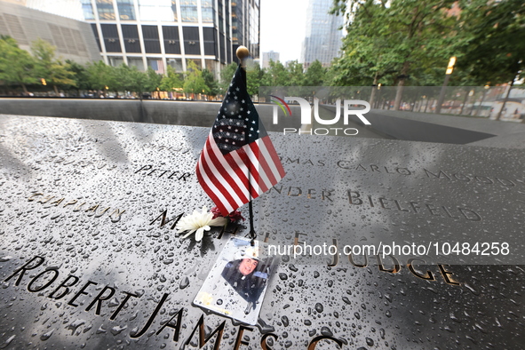 Flowers and US flags are laid on one of the South Pool panels at World Trade Center Memorial to commemorate the 9/11 Anniversary in New York...