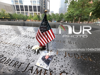 Flowers and US flags are laid on one of the South Pool panels at World Trade Center Memorial to commemorate the 9/11 Anniversary in New York...