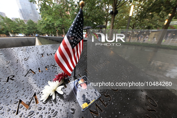 Flowers and US flags are laid on one of the South Pool panels at World Trade Center Memorial to commemorate the 9/11 Anniversary in New York...