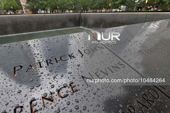 Flowers and US flags are laid on one of the South Pool panels at World Trade Center Memorial to commemorate the 9/11 Anniversary in New York...