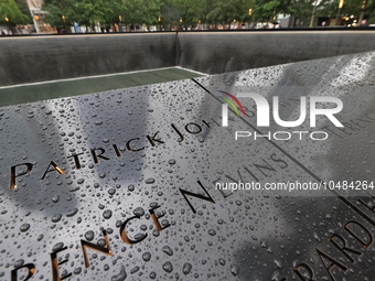 Flowers and US flags are laid on one of the South Pool panels at World Trade Center Memorial to commemorate the 9/11 Anniversary in New York...