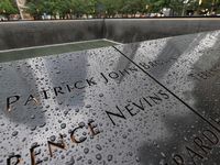 Flowers and US flags are laid on one of the South Pool panels at World Trade Center Memorial to commemorate the 9/11 Anniversary in New York...