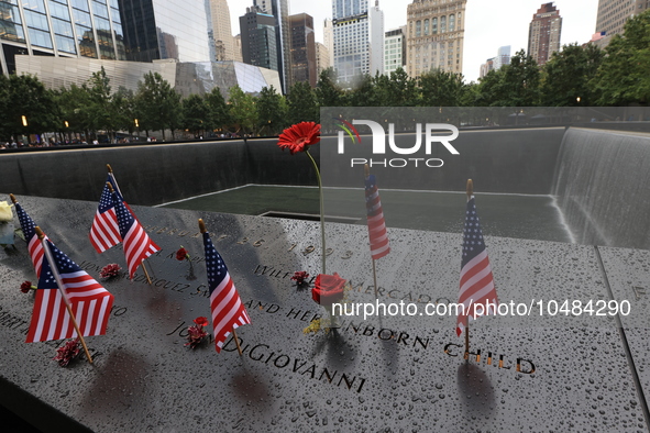 Flowers and US flags are laid on one of the North Pool panels at World Trade Center Memorial to commemorate the 9/11 Anniversary in New York...