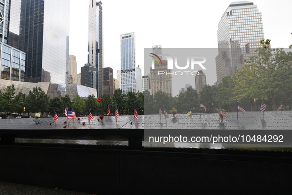 Flowers and US flags are laid on one of the North Pool panels at World Trade Center Memorial to commemorate the 9/11 Anniversary in New York...