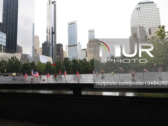 Flowers and US flags are laid on one of the North Pool panels at World Trade Center Memorial to commemorate the 9/11 Anniversary in New York...