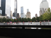 Flowers and US flags are laid on one of the North Pool panels at World Trade Center Memorial to commemorate the 9/11 Anniversary in New York...