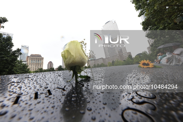 Flowers and US flags are laid on one of the North Pool panels at World Trade Center Memorial to commemorate the 9/11 Anniversary in New York...