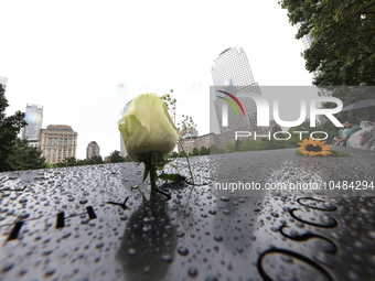 Flowers and US flags are laid on one of the North Pool panels at World Trade Center Memorial to commemorate the 9/11 Anniversary in New York...