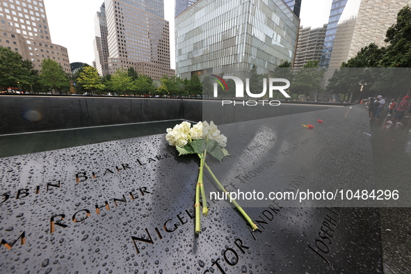 Flowers and US flags are laid on one of the North Pool panels at World Trade Center Memorial to commemorate the 9/11 Anniversary in New York...