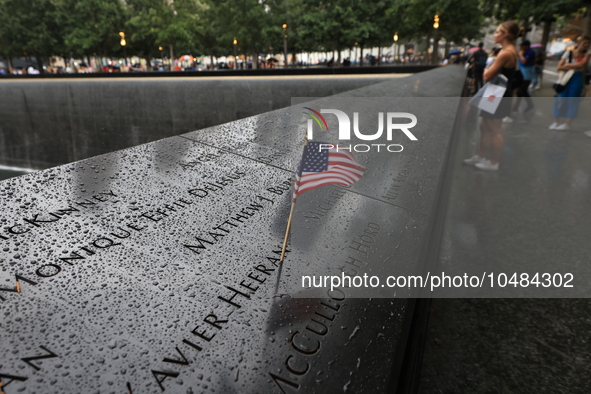 Flowers and US flags are laid on one of the North Pool panels at World Trade Center Memorial to commemorate the 9/11 Anniversary in New York...