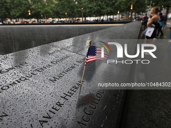 Flowers and US flags are laid on one of the North Pool panels at World Trade Center Memorial to commemorate the 9/11 Anniversary in New York...