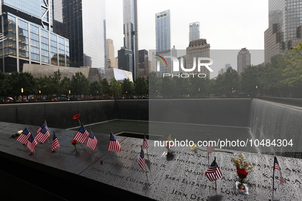 Flowers and US flags are laid on one of the North Pool panels at World Trade Center Memorial to commemorate the 9/11 Anniversary in New York...