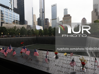 Flowers and US flags are laid on one of the North Pool panels at World Trade Center Memorial to commemorate the 9/11 Anniversary in New York...