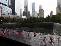 Flowers and US flags are laid on one of the North Pool panels at World Trade Center Memorial to commemorate the 9/11 Anniversary in New York...