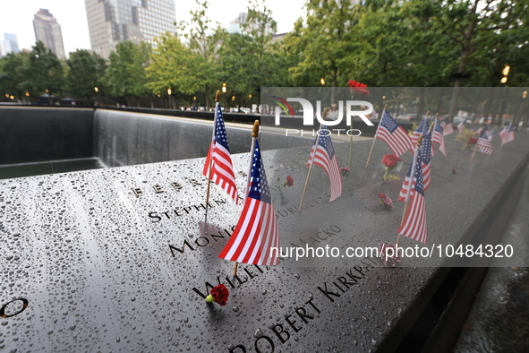 Flowers and US flags are laid on one of the North Pool panels at World Trade Center Memorial to commemorate the 9/11 Anniversary in New York...