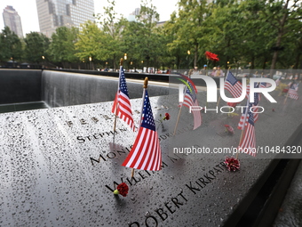 Flowers and US flags are laid on one of the North Pool panels at World Trade Center Memorial to commemorate the 9/11 Anniversary in New York...