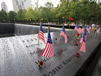 Flowers and US flags are laid on one of the North Pool panels at World Trade Center Memorial to commemorate the 9/11 Anniversary in New York...